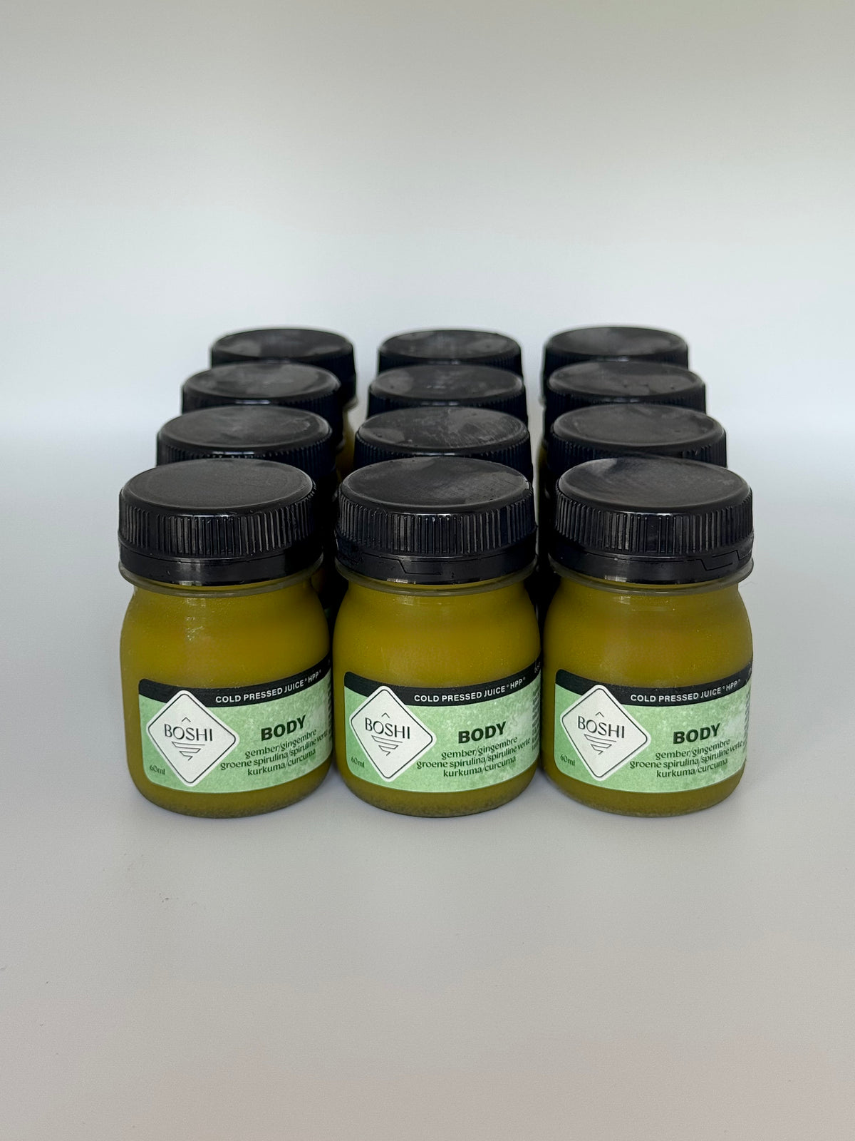 Twaalf flesjes Boshi Body gembershot van 60 ml, zoals in de box